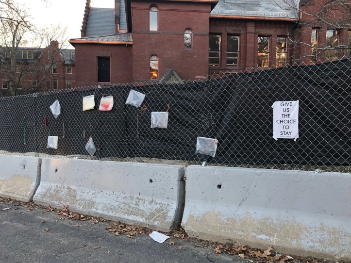 COVID-19 signs on fence at Smith College